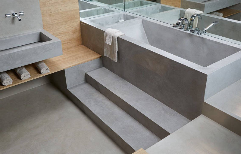 Raised grey bath with steps and timber bathroom details