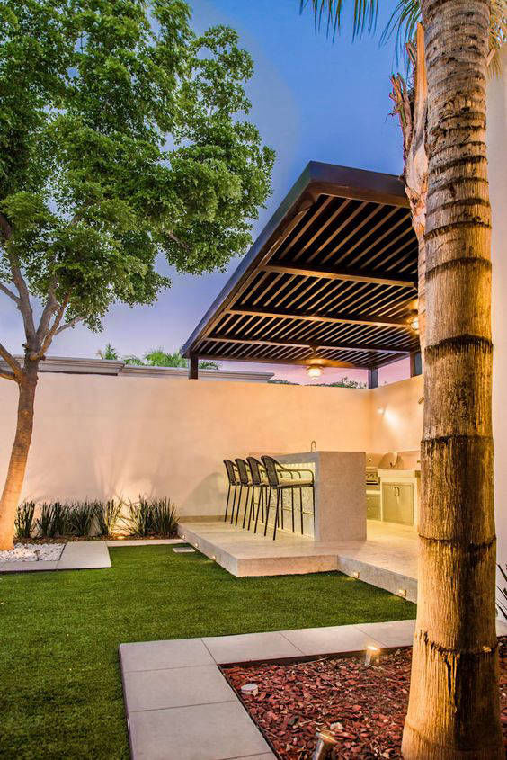 Warm-toned garden wall beside a pergola and palm tree