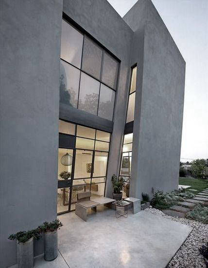 Dark grey façade framing tall glazing