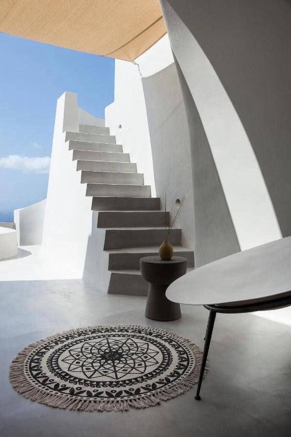 White outdoor staircase opening onto a sea view