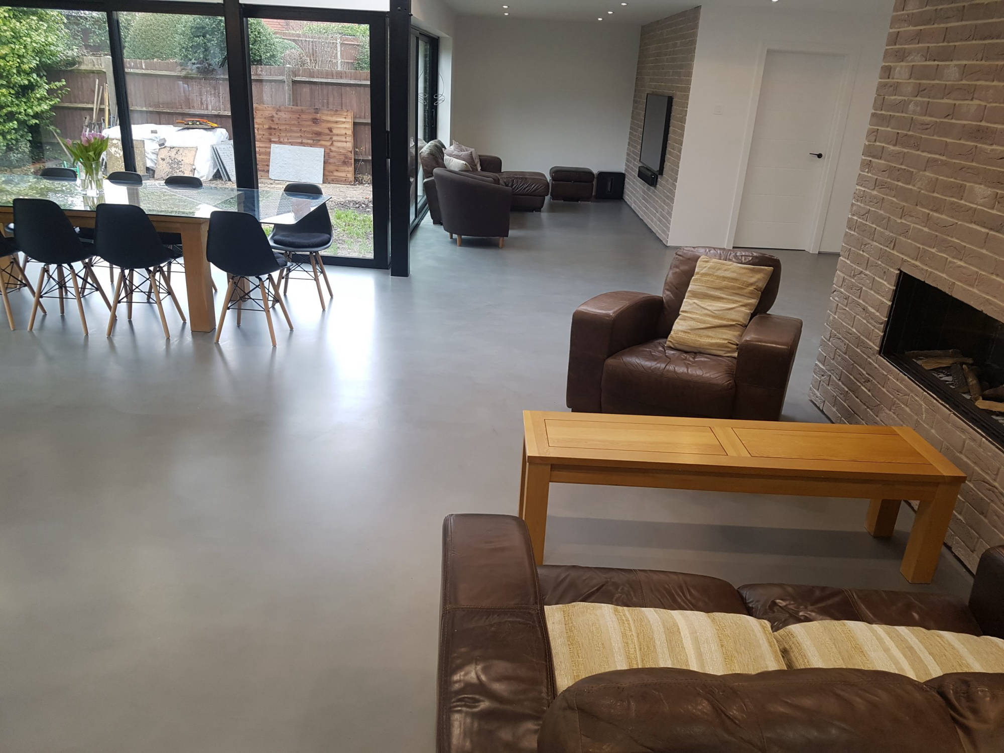 Light-toned seamless flooring in a spacious seating area