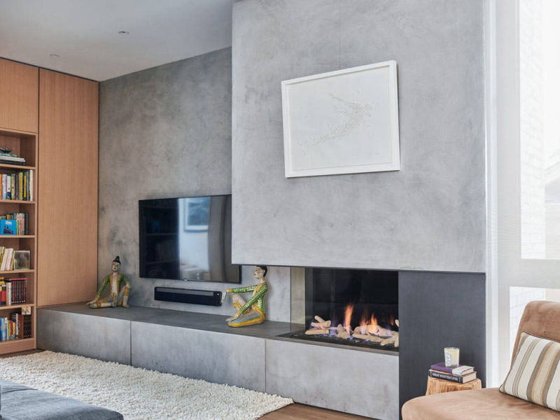 Grey fireplace wall integrated with a television unit