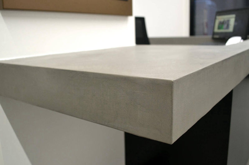 Thick edge and corner detail of a light grey tabletop