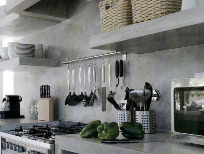 Grey wall with hanging kitchen utensils and open shelves