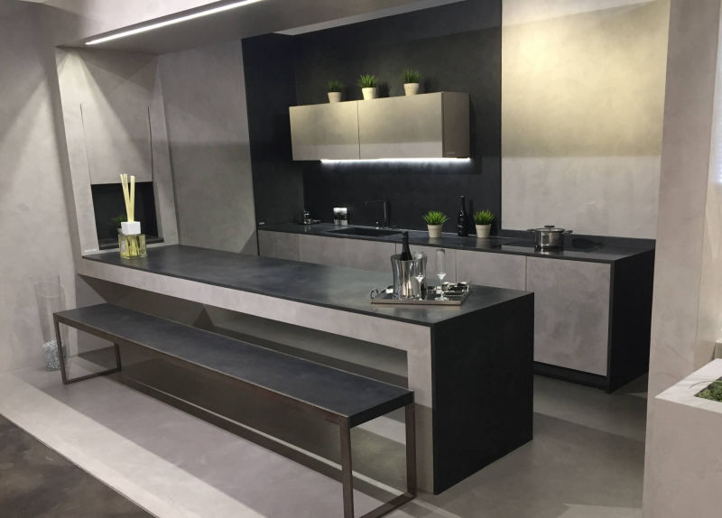 Grey kitchen surfaces with a dark island and bench