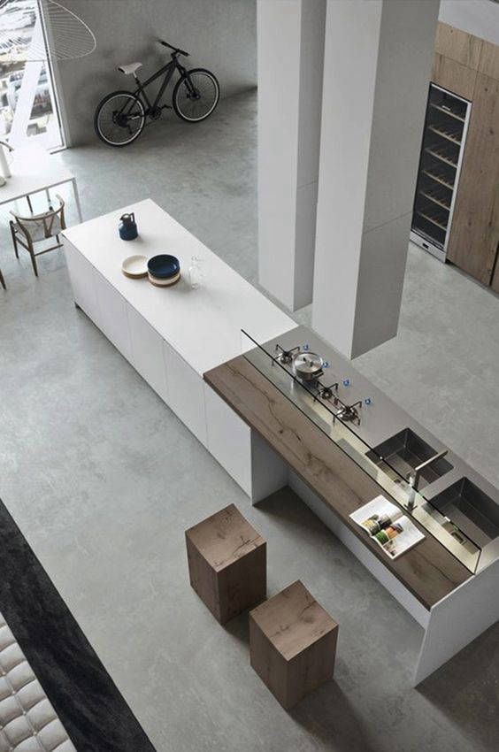 Overhead view of a long kitchen island and light grey floor