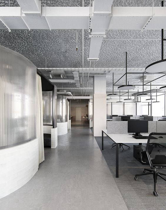 Grey office corridor following a curved partition wall