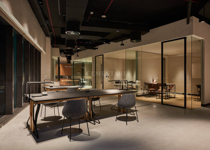 Wide grey floor in a shared workspace with a black ceiling