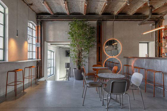 Dining area with grey walls and flooring beneath timber ceiling beams