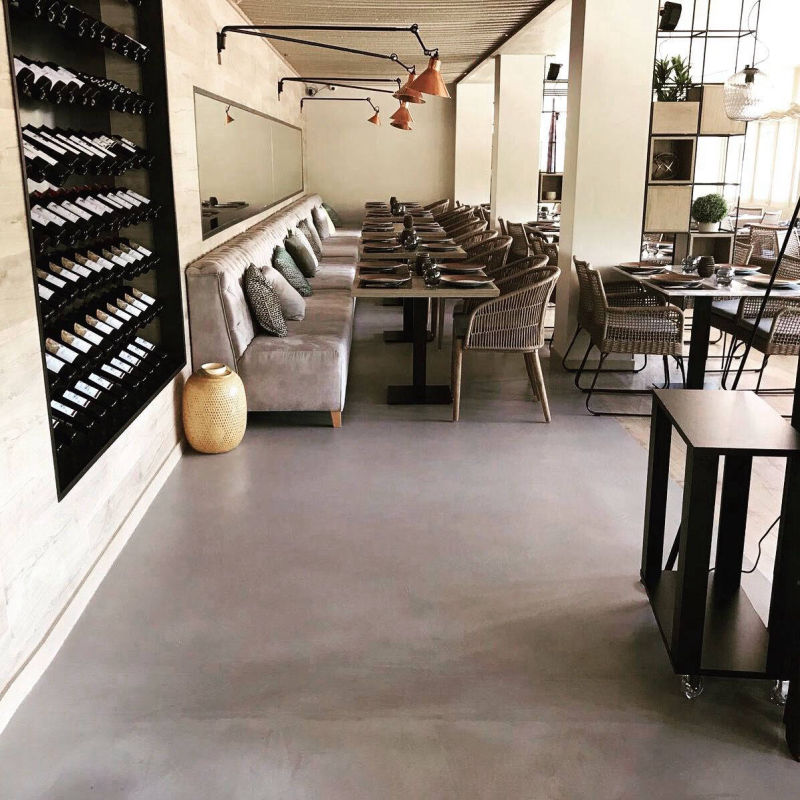Light grey restaurant flooring between bottle shelves and dining tables