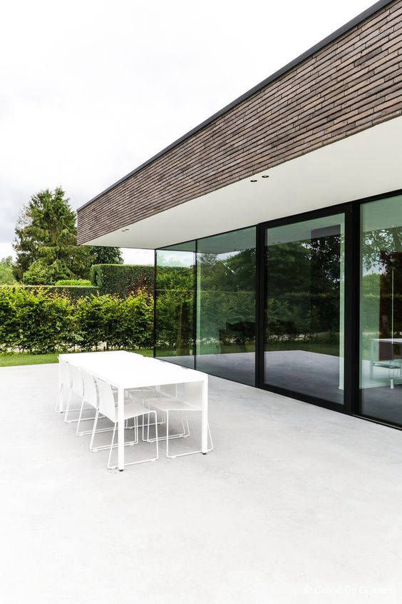 Light-coloured flooring on a dining terrace in front of glazing